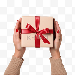 女手握着白木上红丝带包装的圣诞