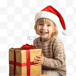 戴圣诞帽的男孩图片_戴着圣诞老人帽子的孩子坐在圣诞