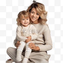 人在装饰圣诞树图片_母亲拥抱她的小女儿，坐在装饰好