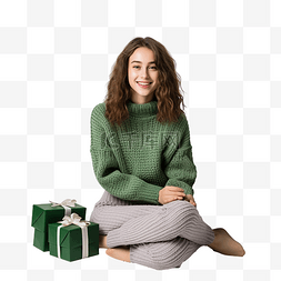 坐在地毯图片_圣诞树上，一个穿着针织毛衣的女