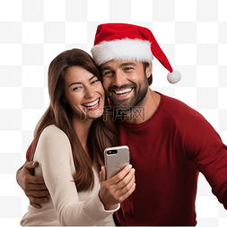 用手机的情侣图片_戴着圣诞帽拥抱微笑的丈夫和妻子