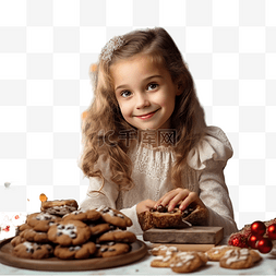 吃饼干小女孩图片_小女孩在圣诞树的背景下沉迷于饼