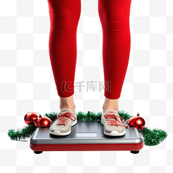 體重秤图片_女脚站在电子秤上，穿着圣诞装饰