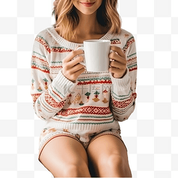 拿着杯子的女人图片_圣诞树旁床上穿着针织毛衣和及膝