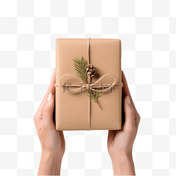 装礼物的盒子图片_手拿着白桌上包裹着牛皮纸和纸卷