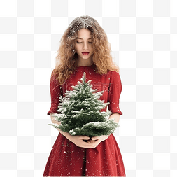穿着红裙子抱着雪圣诞树的女孩