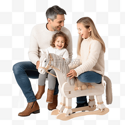 快乐的小孩坐在图片_一个小孩坐在她父母旁边圣诞树附
