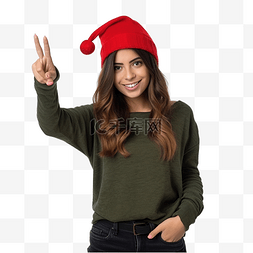 孤立的墙上戴着圣诞帽的年轻女孩