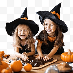 两个穿着女巫服装烘烤饼干的小女
