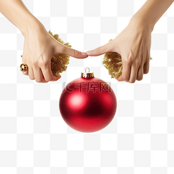 红金色球图片_女手拿着两个金色圣诞树小玩意穿