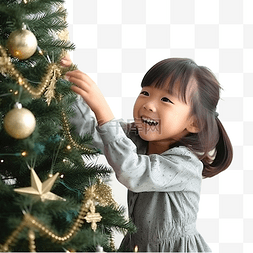 亞洲小女孩图片_亚洲小女孩正在装饰圣诞树，享受