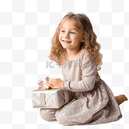 老人节日图片_小女孩坐在圣诞树旁，手里拿着礼