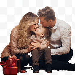 父母亲吻孩子图片_父母亲吻坐在圣诞树附近地板上的