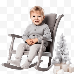 可爱的小男孩坐在圣诞树附近的摇