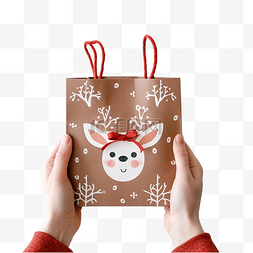 圣诞礼物袋图片_手里拿着可爱的驯鹿装饰的圣诞礼