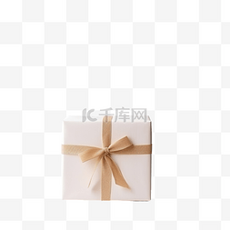 白色的领结图片_木桌上白盒子里的圣诞礼物，上面
