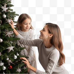 快乐的女孩和她的母亲装饰圣诞树