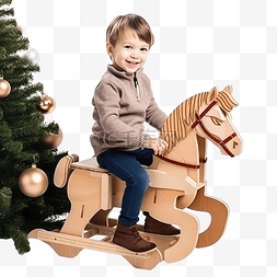 玩游戏的男孩图片_小男孩在圣诞树附近骑着纸板马