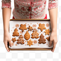 一个女孩的手在烤盘上拿着圣诞饼