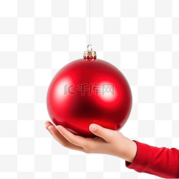 抱球孩子图片_圣诞节日落时拿着红色圣诞球的孩