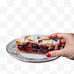 桌子上的蛋糕图片_手拿一块樱桃派放在圣诞装饰的桌