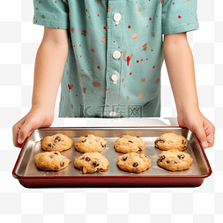 饼干原料图片_一个男孩的手在烤盘上拿着圣诞饼