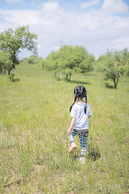 夏天行走在草地上的小女孩