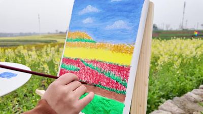 自然春天美女菜花田画画油画实拍实拍素材