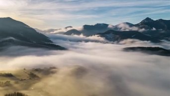 1080延时摄影雾蒙蒙的山景空中全景雾蒙蒙的云彩在美丽的自然中快速移动在金色的日出中飞逝旅行背景