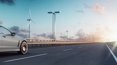 日落时带风力涡轮机的公路上通用电动汽车驱动的3D渲染